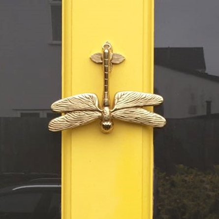 Dragon Fly Door Knocker in brass on yellow door
