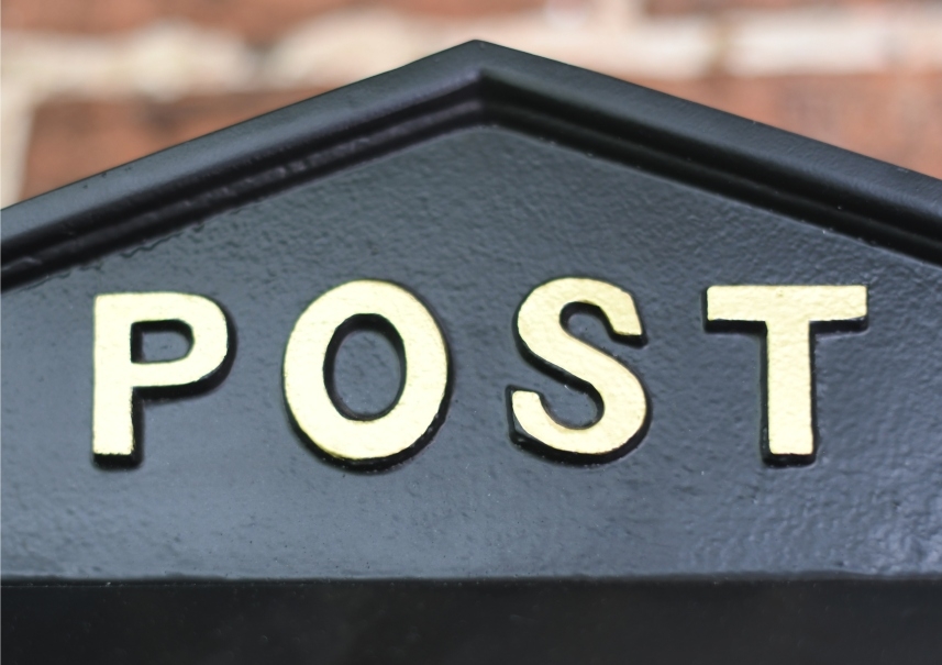 Close up of gold post box 